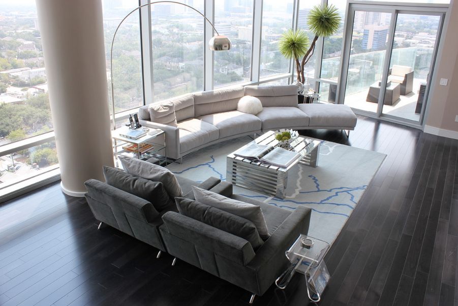 Modern living room high ceiling with big views and curved sofa