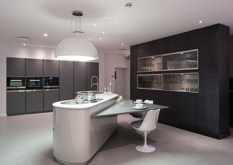 Contemporaty grey kitchen featuring a saarinen tulip amrchair