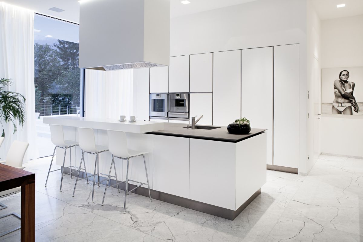 Modern white kitchen with marble floor and large kitchen island