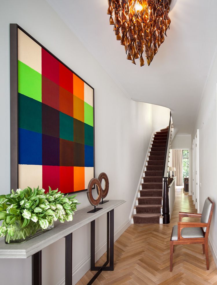 Modern art is a colorful pop in this sophisticated entryway.