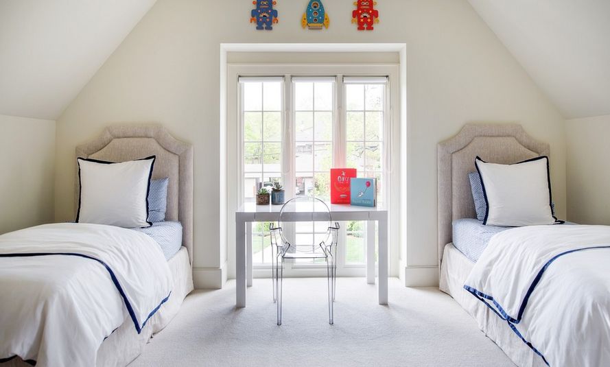 Light and airy, the clear chair in this bedroom does not compete with the view through the beautiful window.