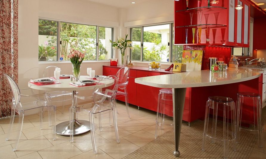 Red kitchen design whit ghost chairs for dining