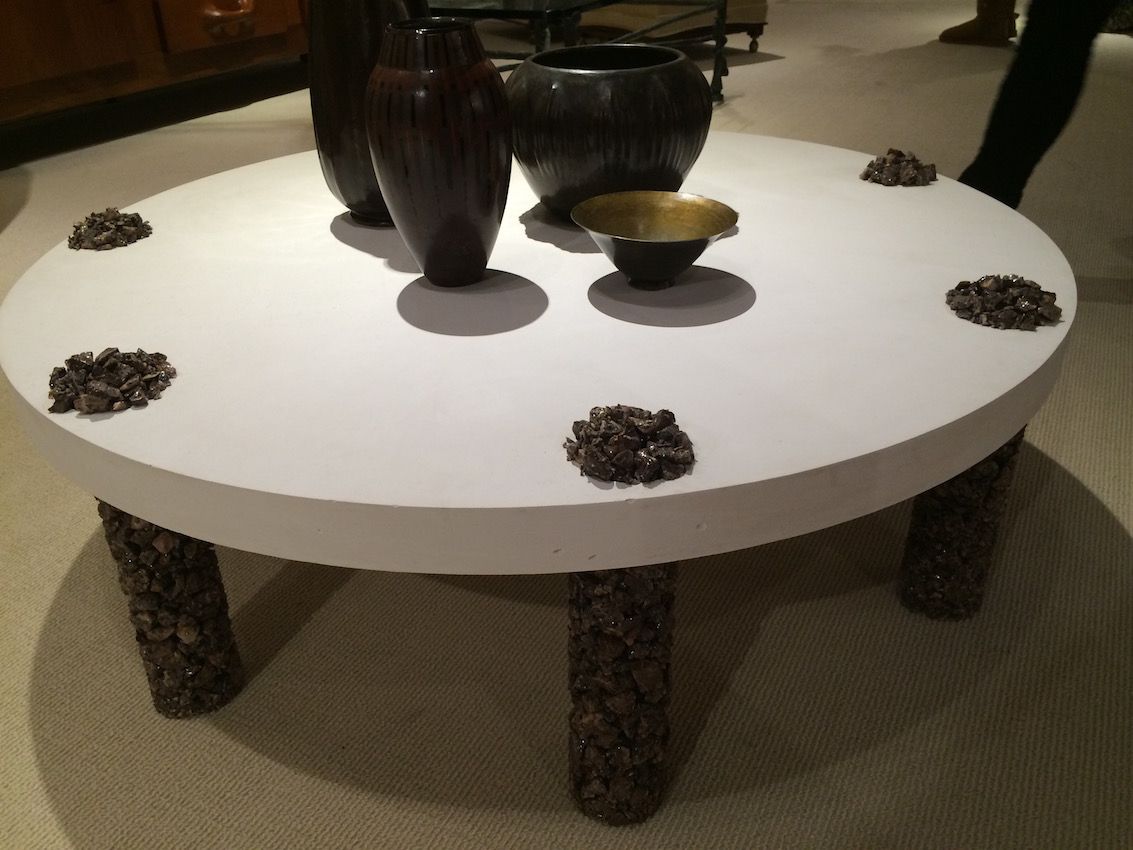 This coffee table features crushed stone on the legs, as well as on top, as a decorative element.