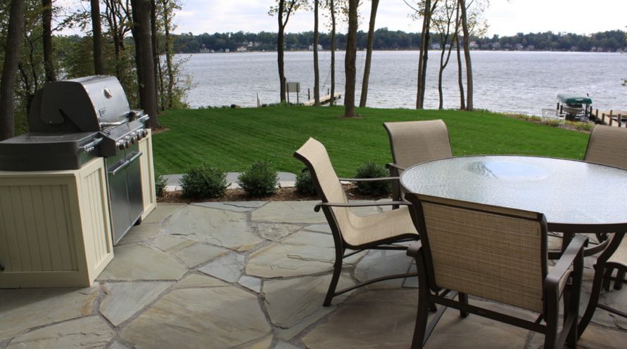 Flagstone also works wonderfully for traditional patios, regardless of the surroundings [Design from Arcadia gardens LLC ]