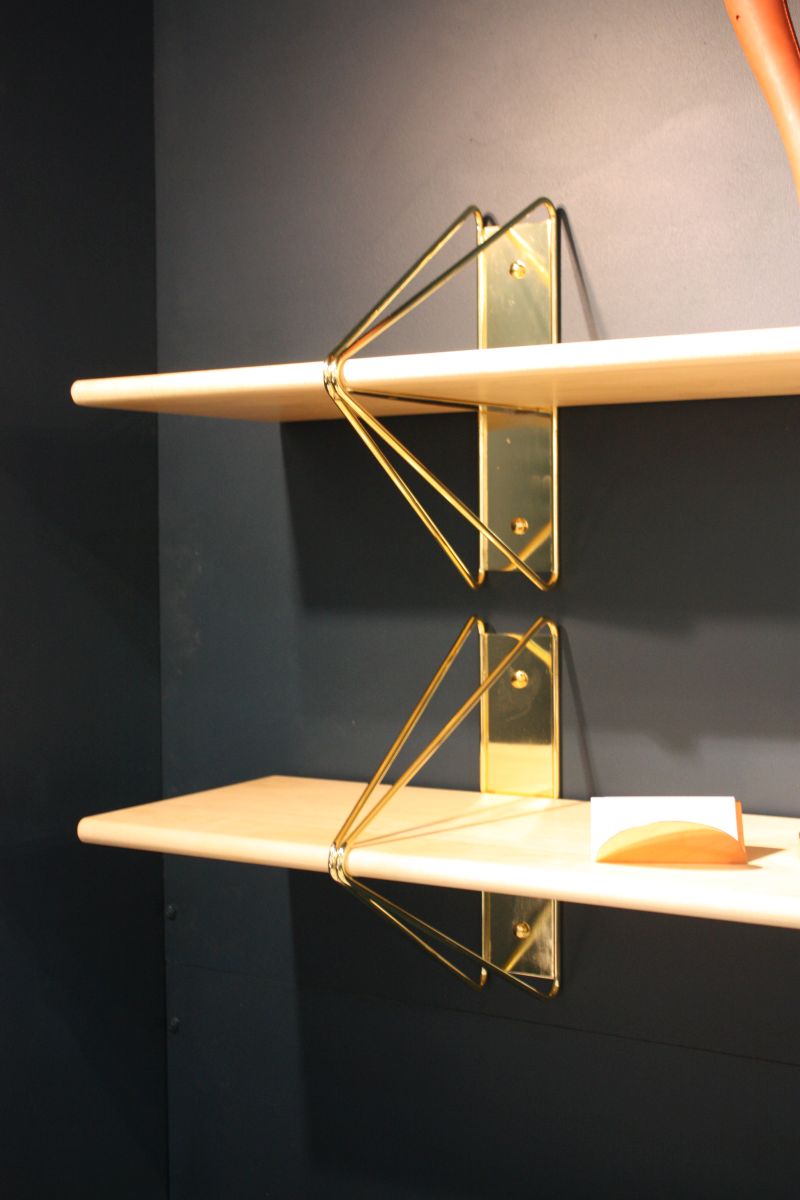 Floating shelves with gold brackets