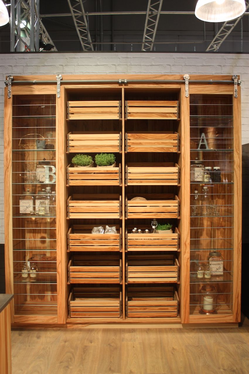 In shelving like this, it's not just the wood that provides a rustic, country flavor: it's the design itself. The sliding barn-style doors are glass and give the entire unit an open feel.