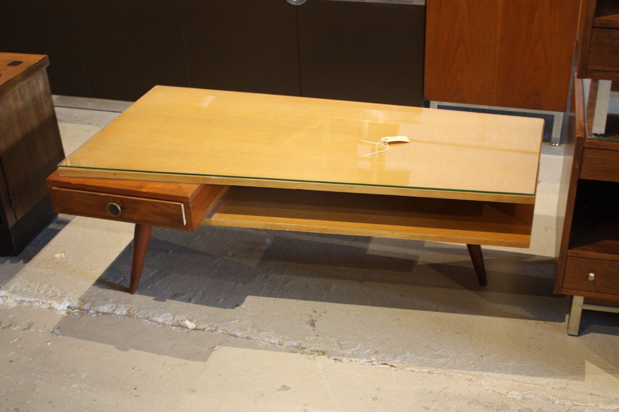 What a fantastic find! This mid century coffee table is amazing, from its unique shape, mix of woods, slim drawer and elegant legs.