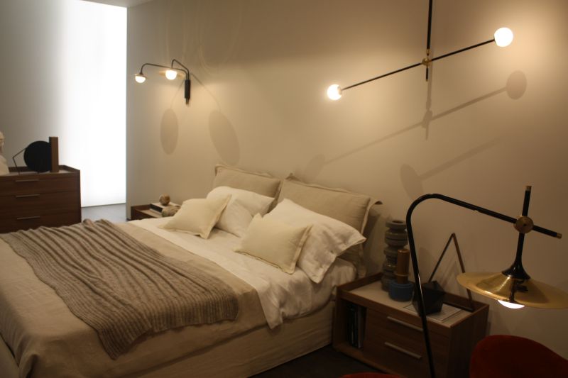 Modern wall lights above the bed - cream bed