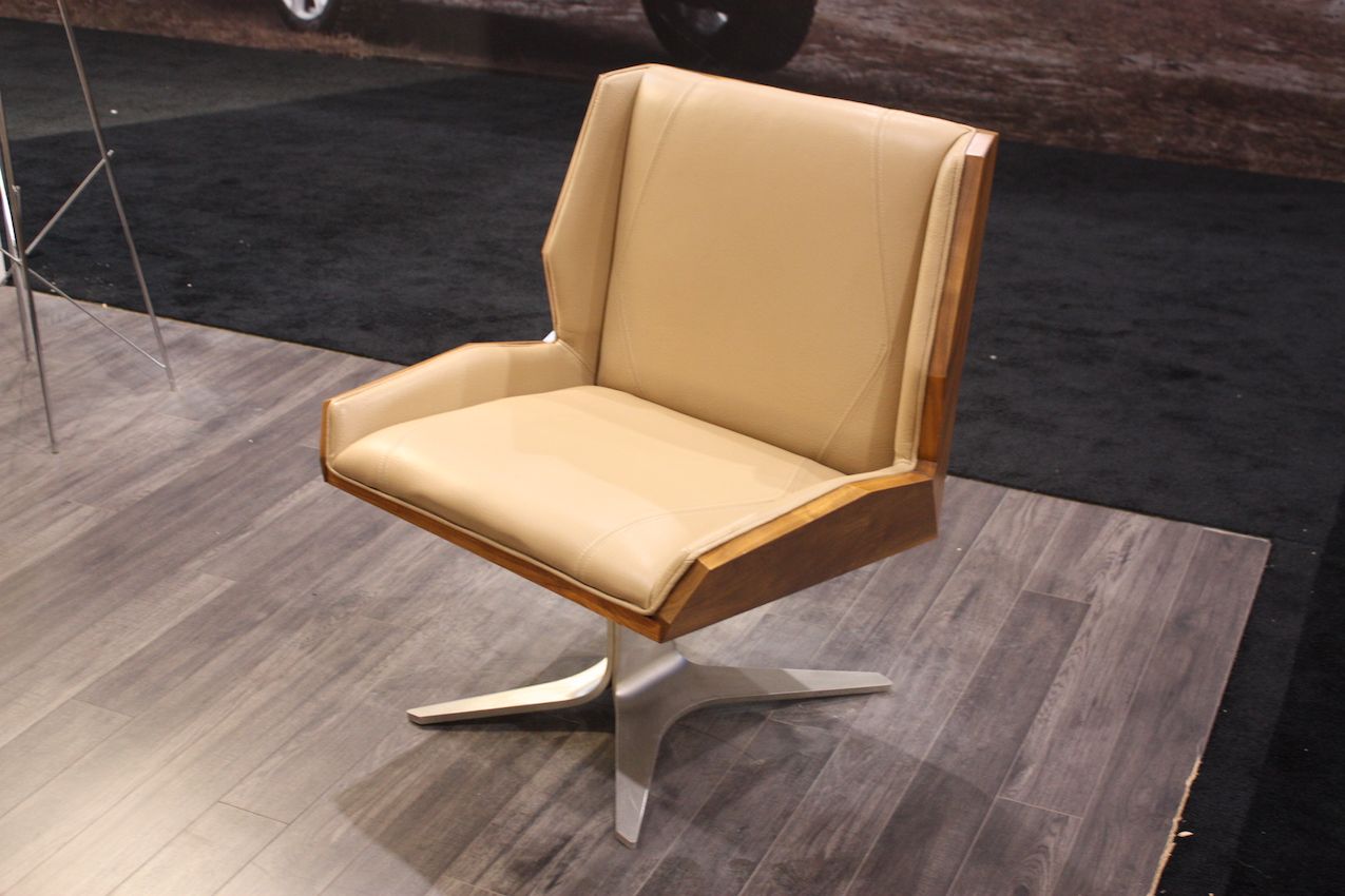 Modern chair with mid-century style flair -- this would be perfect in a conversation area or in an office. We love the mix of leather upholstery, wood frame and metal base. Both the chair frame and base have unexpected lines.