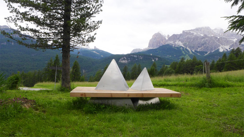 Wood bench with mountains around it