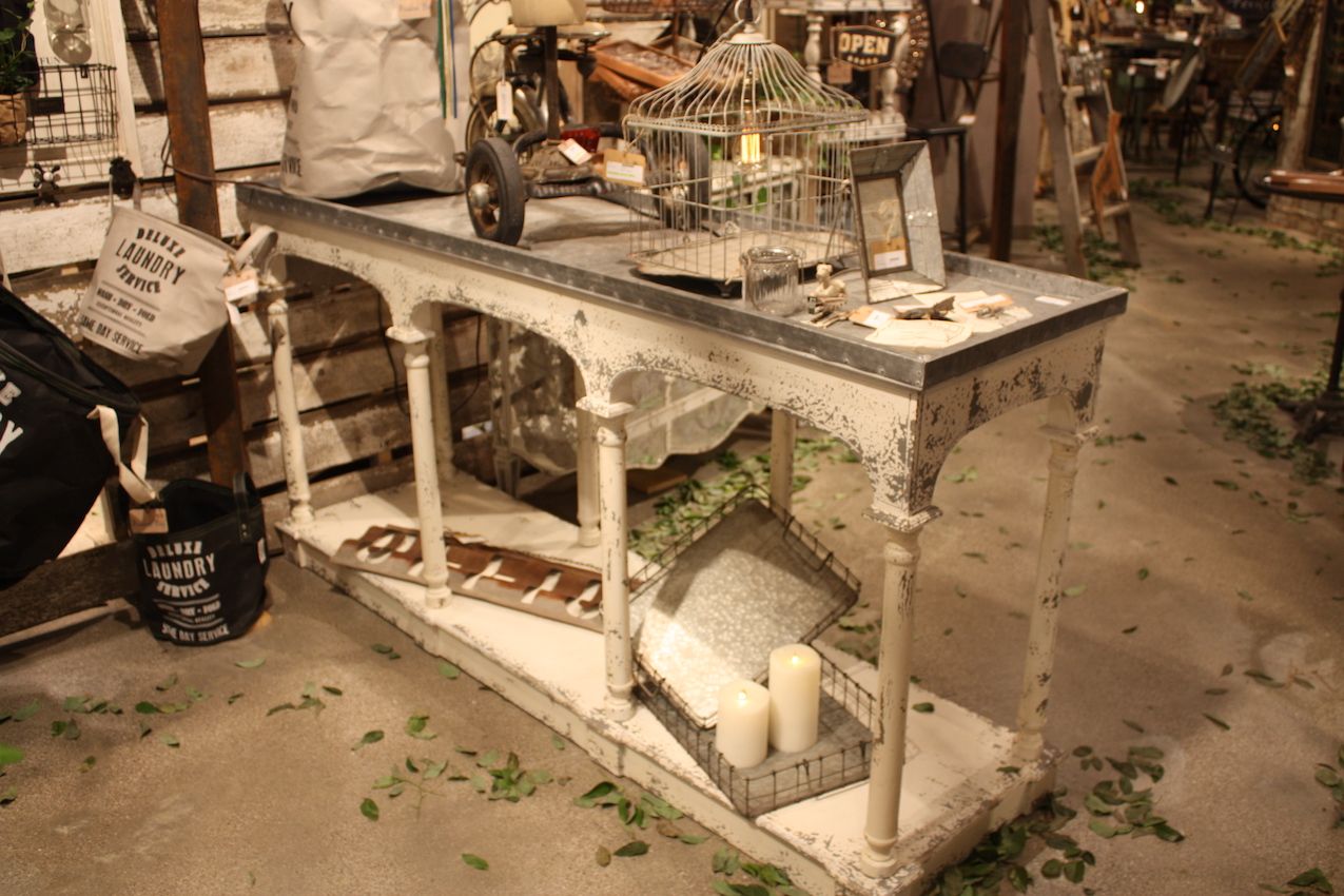 Peacock Park plays up the distressed look of this console with plenty of rustic accessories.