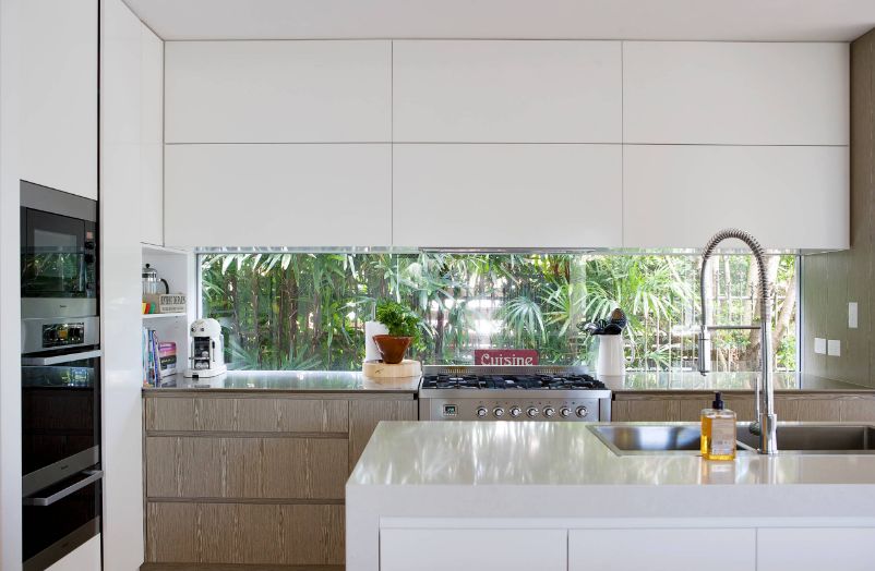 Open space kitchen with a letterbox window above countertop