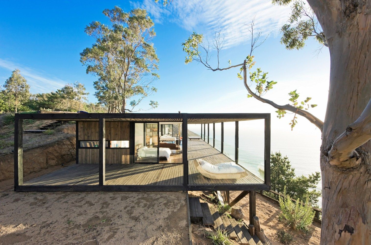 Till house built on the edge of a cliff deck porch