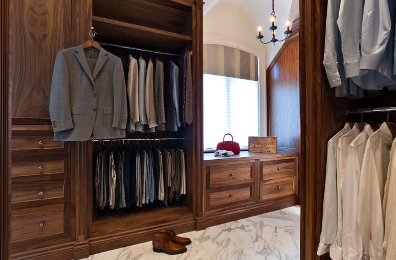 Walk in closet with marble floor