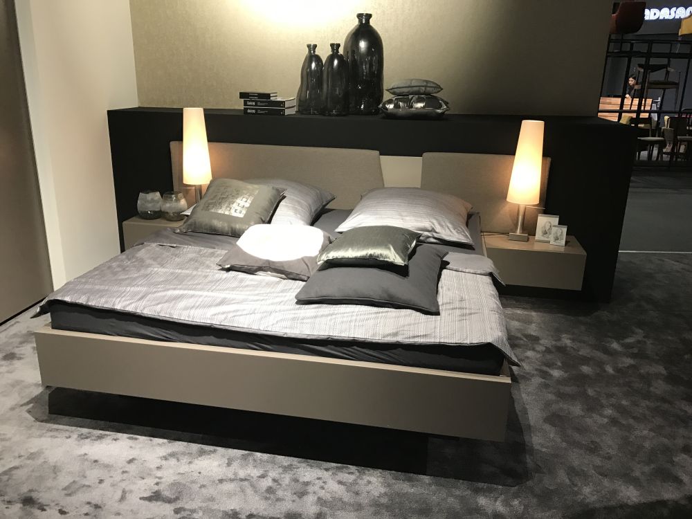 Floating platform bed with nighstands and an interesting headboard design