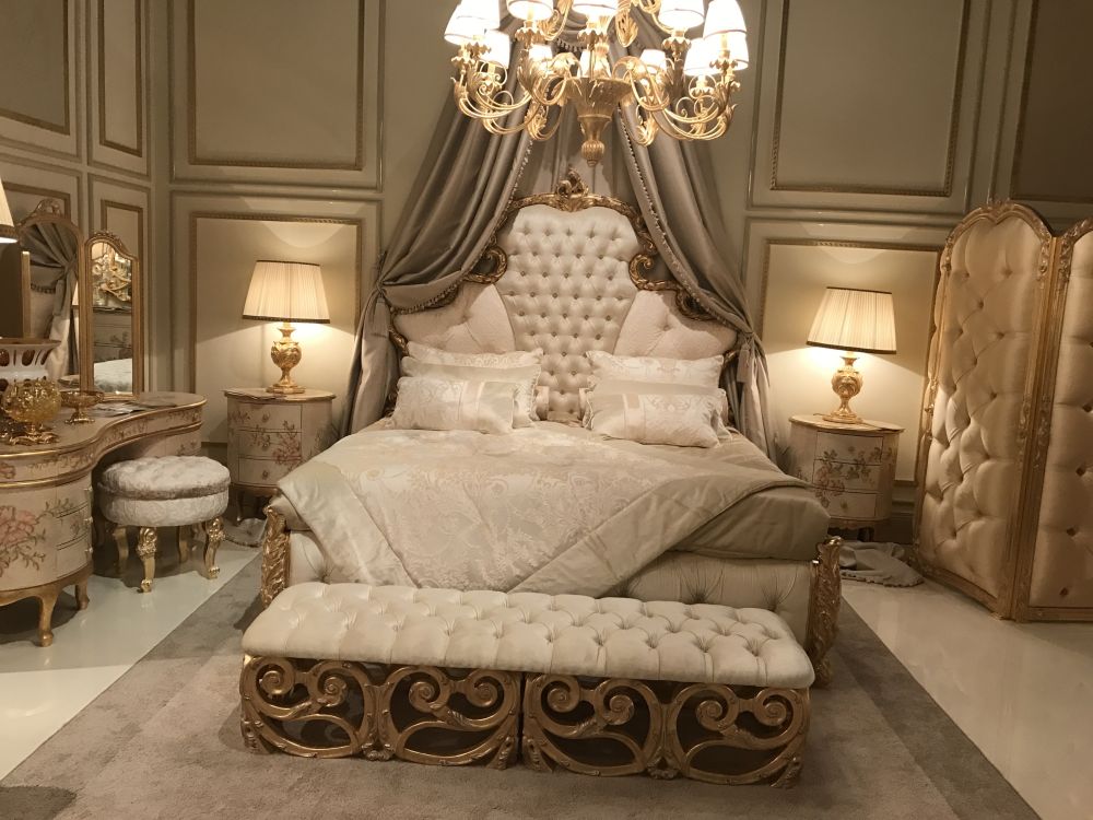 Master bedroom with a luxury baroque style featuring a tufted bench and folding screens