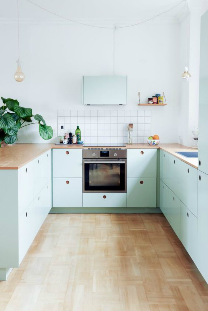 Mint green landry room with gray tiny tiles for backsplash