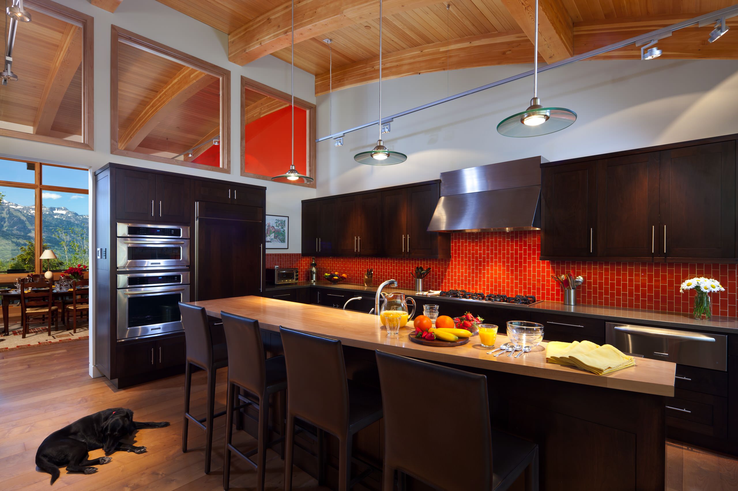 Contemporary kitchen orange backsplash black cabinets