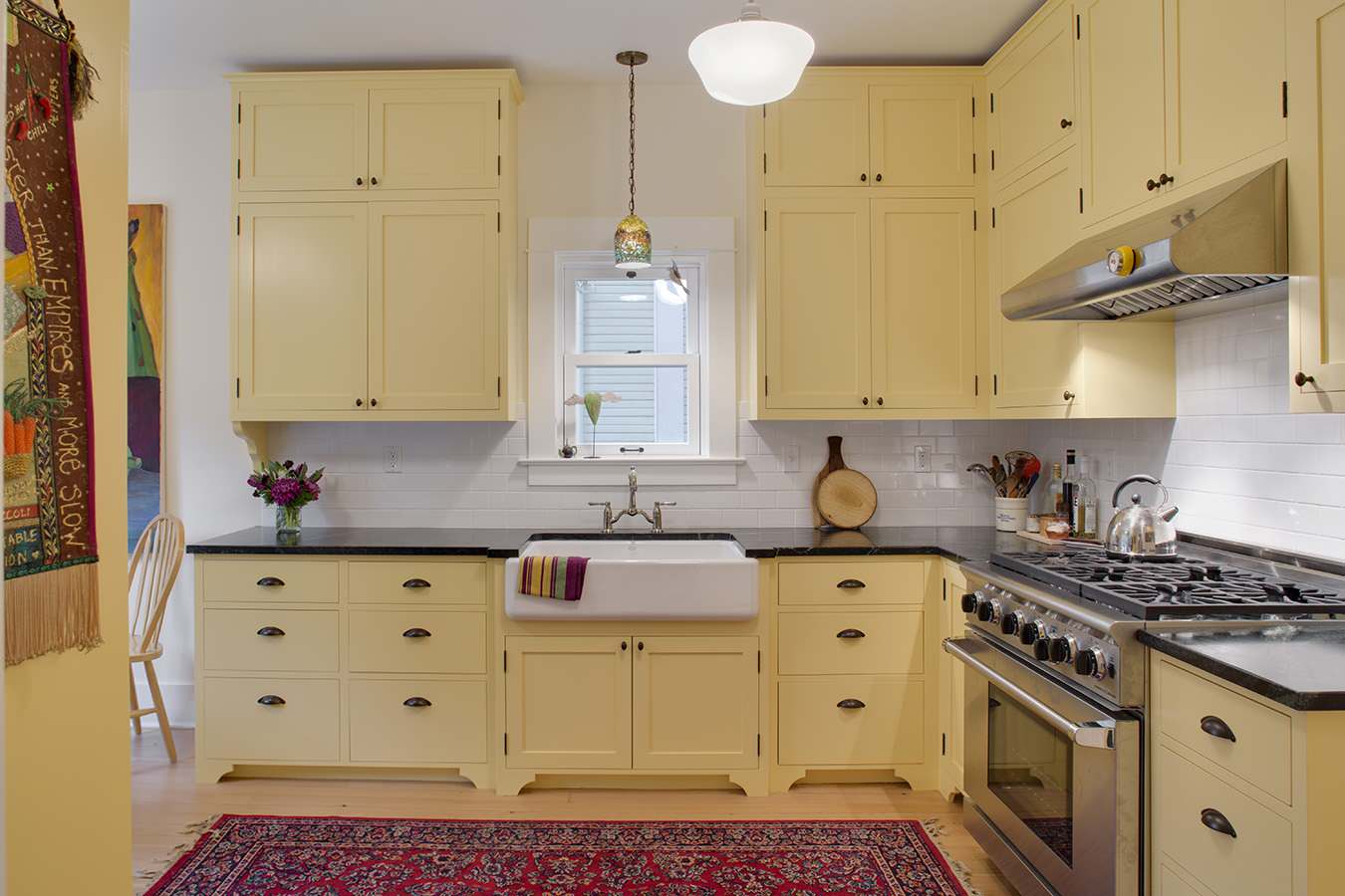 Eclectic kitchen yellow cabinets bright rug