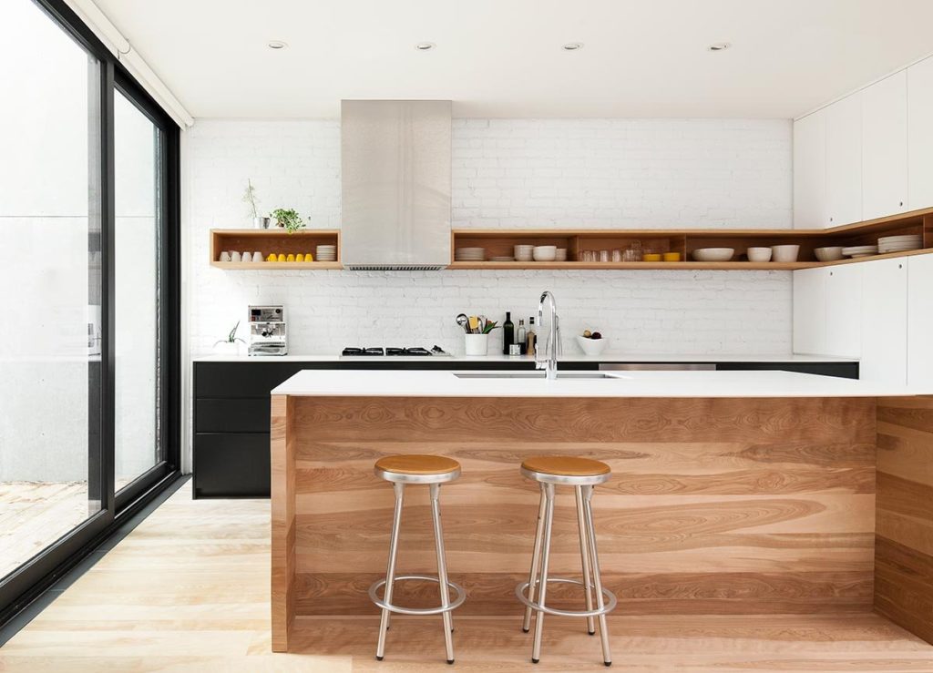 White kitchen wood island black cabinets