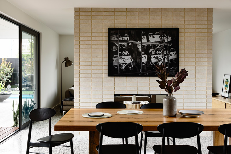 Melbourne dining room with wall art on a brick wall