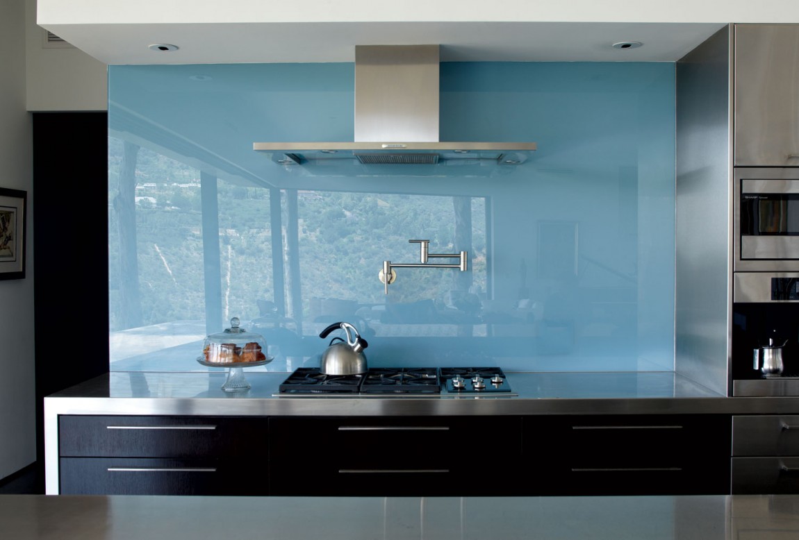 Green glass kitchen backsplash with shelves