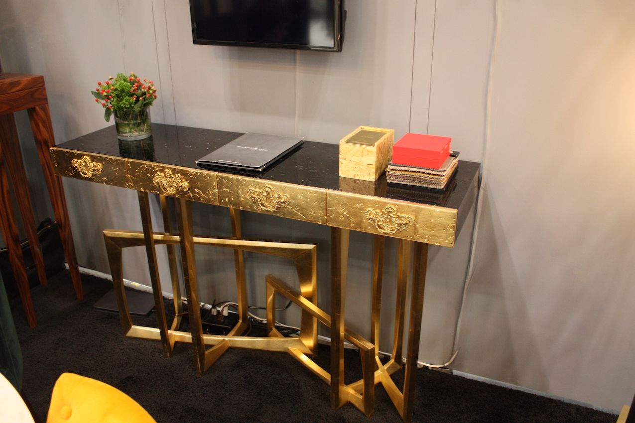 A fully gilded console table from Covet Lounge is a stately yet modern golden piece.