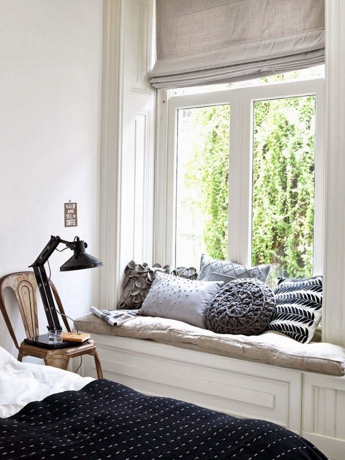 A modest window seat with gorgeous textured pillows is perfect.