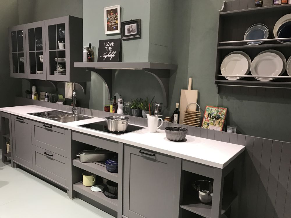 Modern kitchen layout with stainless steel legs on cabinets