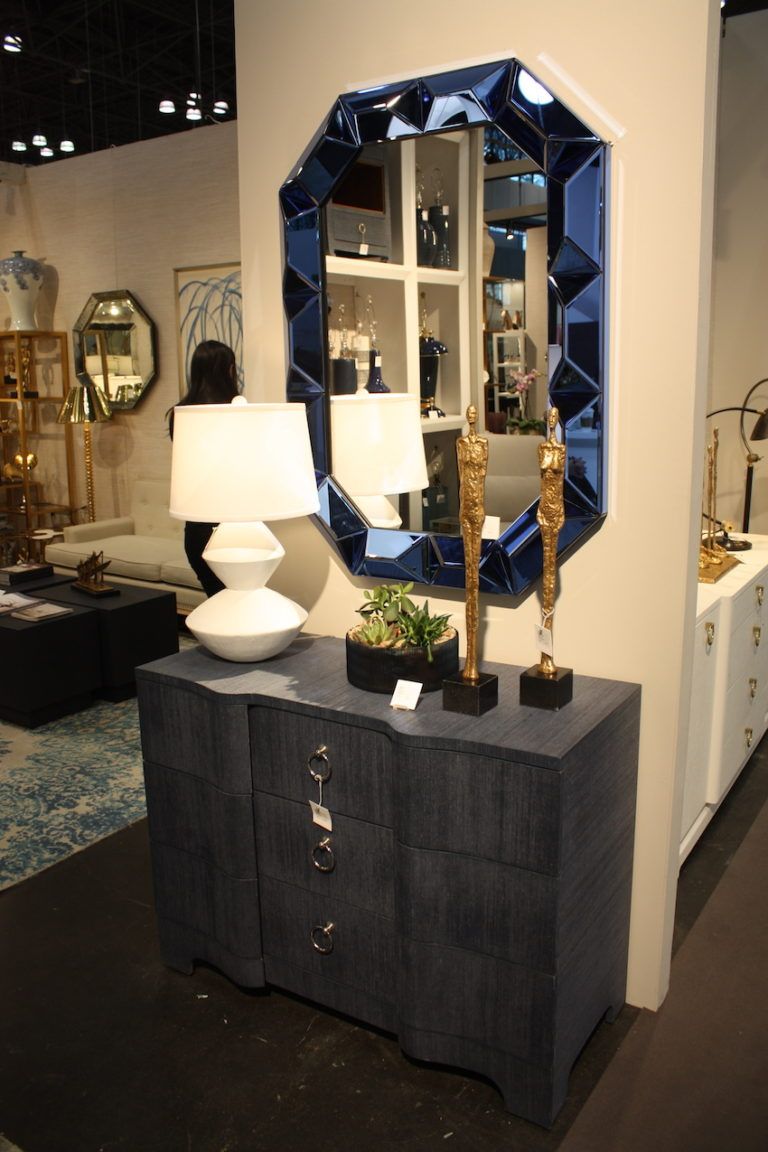 The understated chest allows the jewel-like design of the mirror to be the focus.