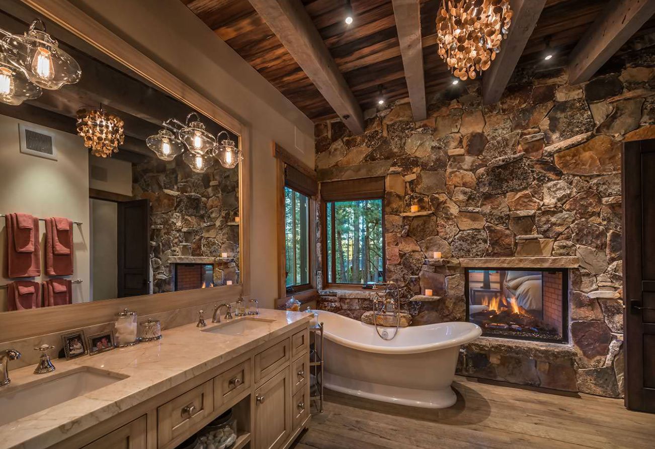 Rustic bathroom with fireplace and clawfoot bath