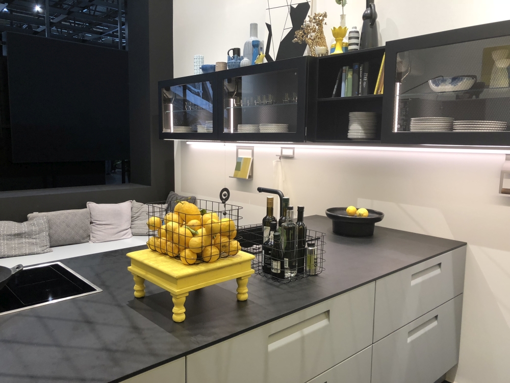 Modern kitchen with large island with bar area and black marble countertop