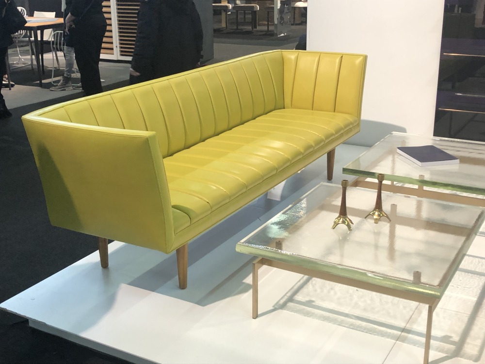 Yellow leather couch and small glass table