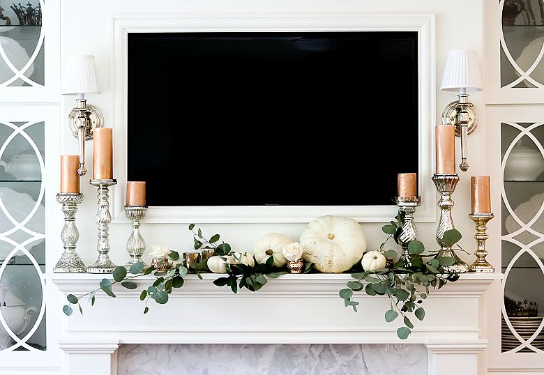 Spray painted faux white pumpkins to decorate the mantel