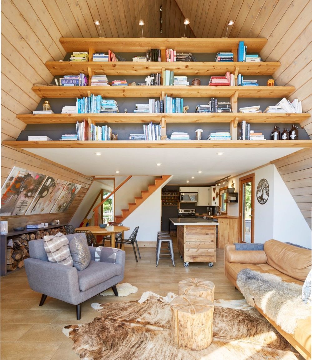 The interior is organized on two floors, the upstairs featuring a custom shelving unit which doubles as a divider