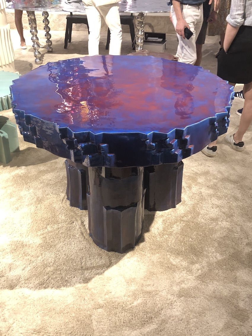 The glossy top and layered design make this table a focal point.