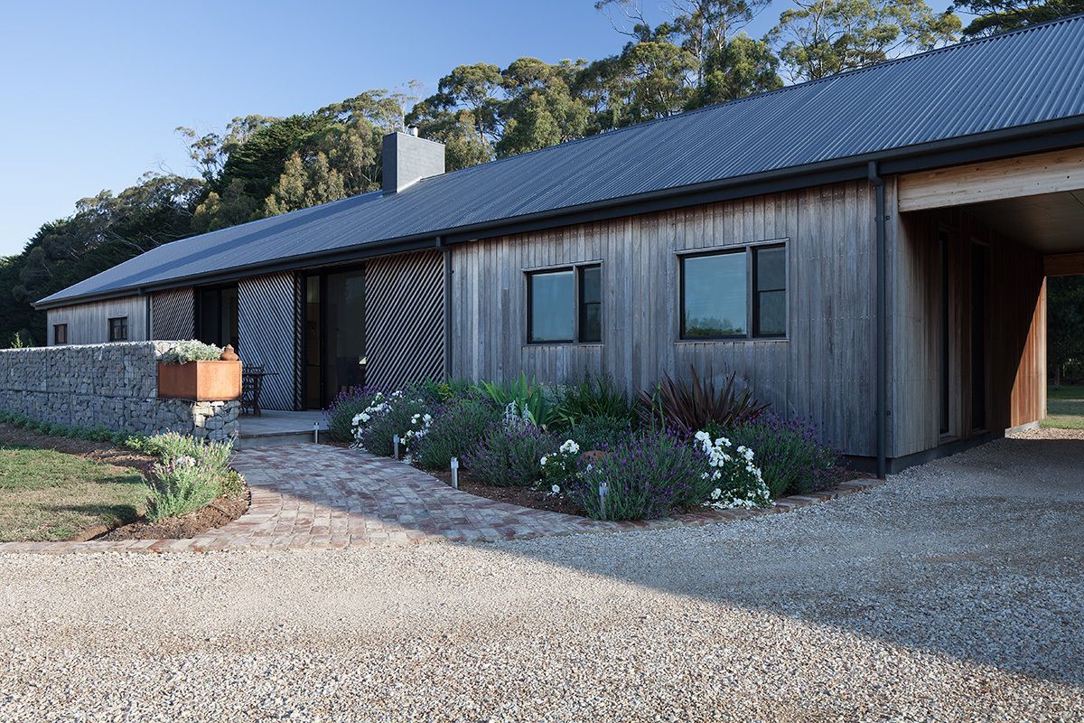 The natural patina of the wood-clad facades helps the house blend in more easily