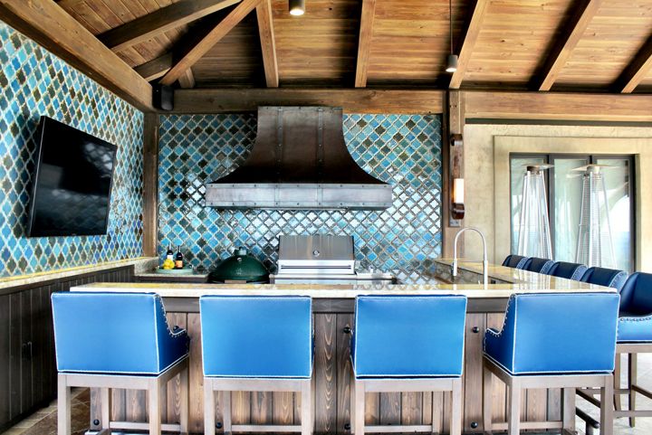 An L-shaped bar helps to frame the kitchen in an open floor plan