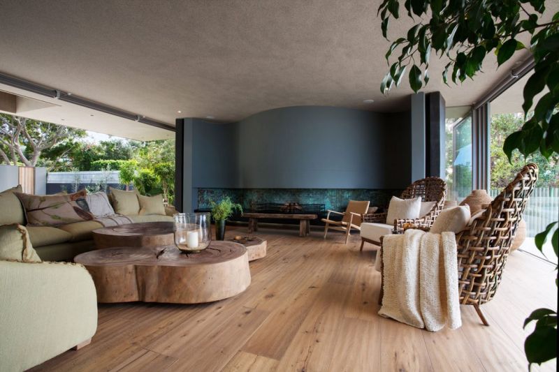 Contemporary living room with polished floor and wood tables