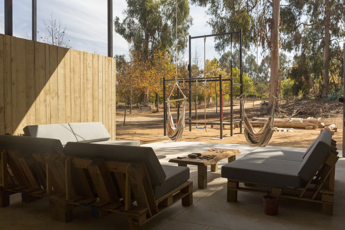 The covered outdoor area is a multifunctional space perfect for lounging and relaxing