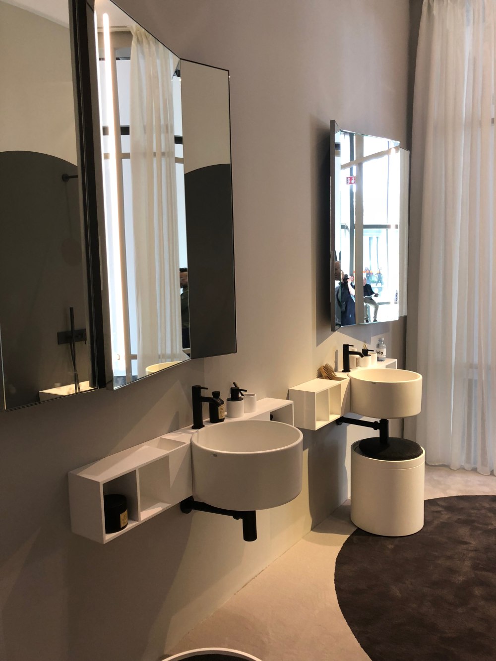 The design and geometry of both the vanities and the mirror add a lot of character to the room