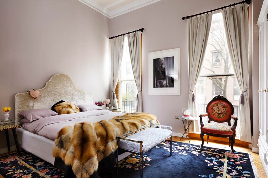 Bedroom with fur blanket and blue carpet