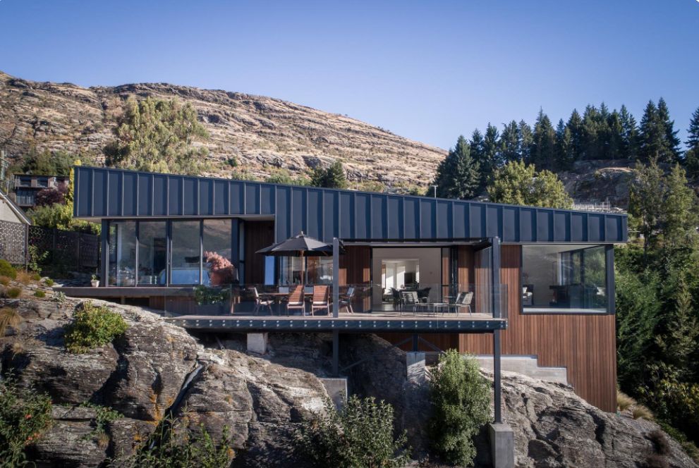 This Hillside Home With Black Metal Siding