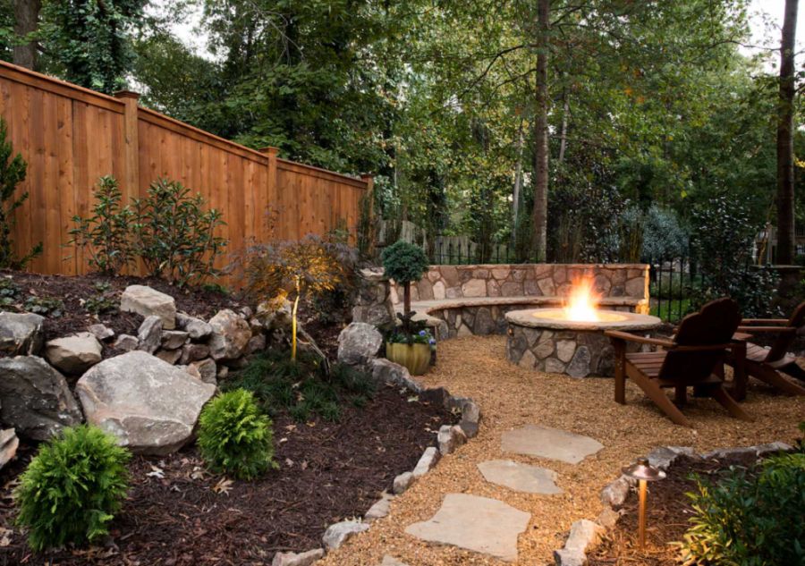 Rustic full sun backyard gravel landscaping in Atlanta with a fire pit