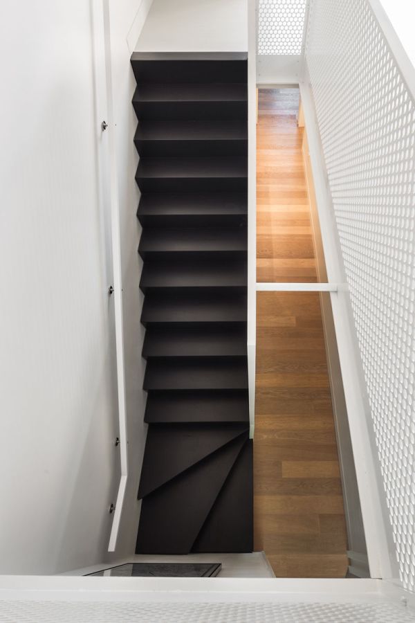 Black stairs with white railings