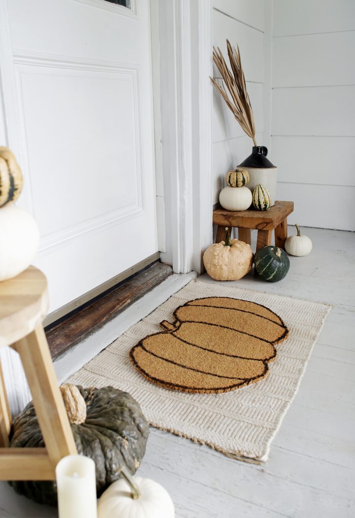 A cute pumpkin-shaped doormat