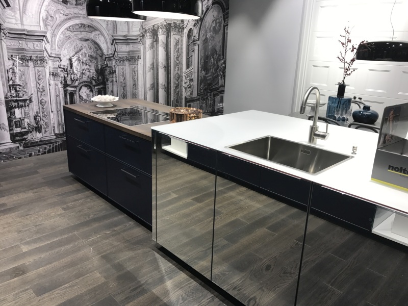 Mirror panels make the floor appear to continue under the island