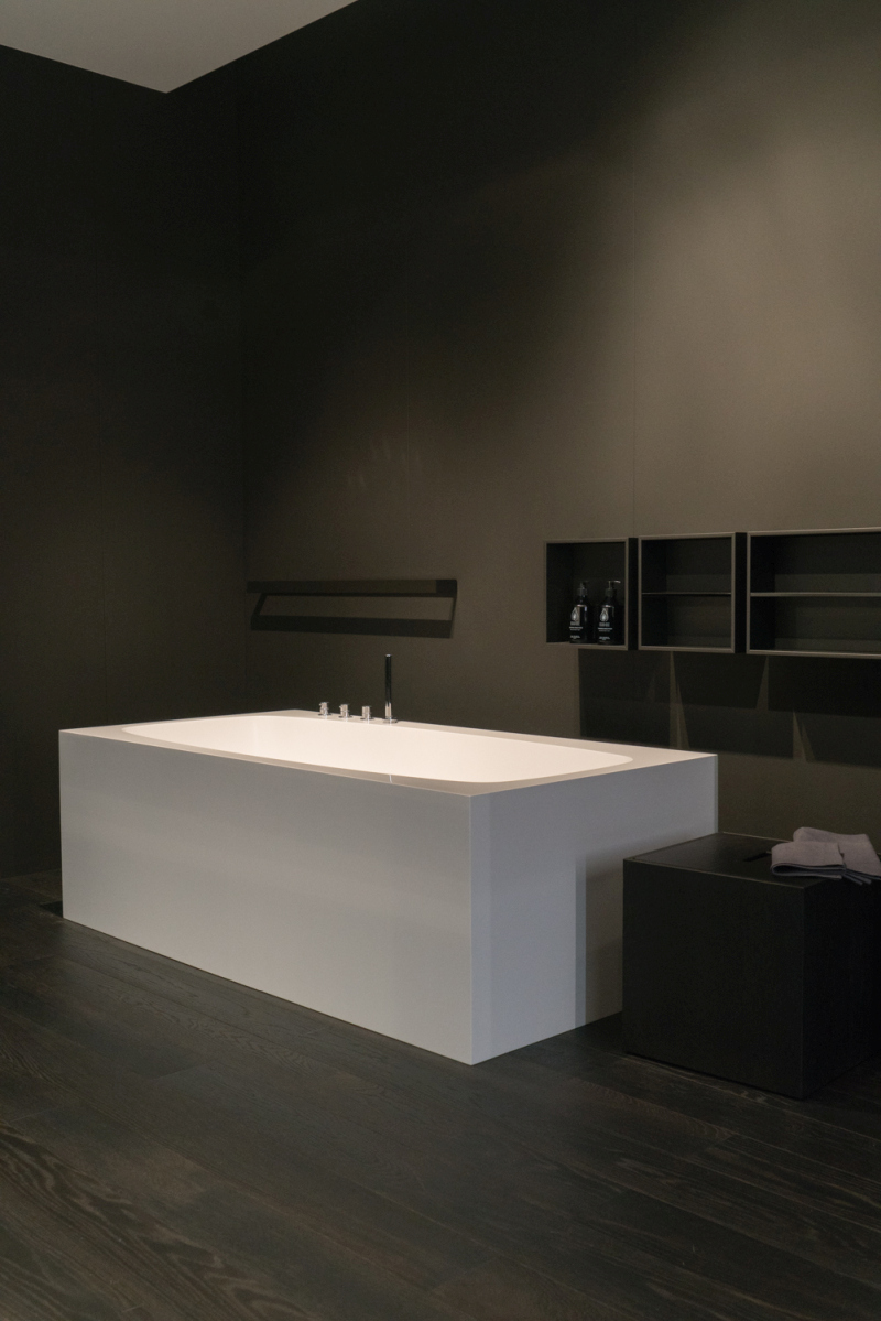 A Rectangular White Tub Creates a Sharp Outline Against Dark Walls