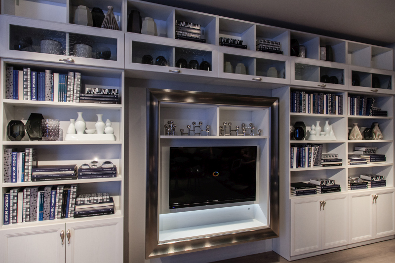 A television framed by an entire wall of storage