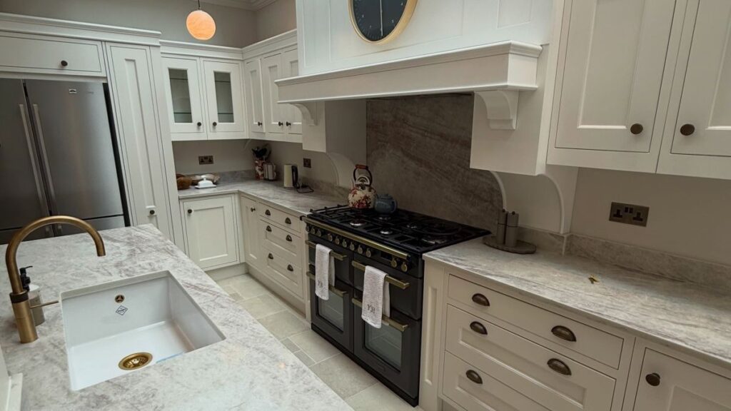 An Oak Kitchen Island Reveals a Curved Seating Nook on the Other Side